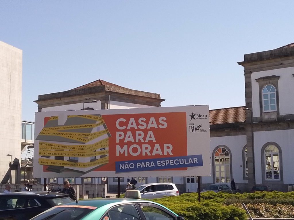 Pictured: "Houses for living, not for speculation" billboard outside a metro station in Lisbon