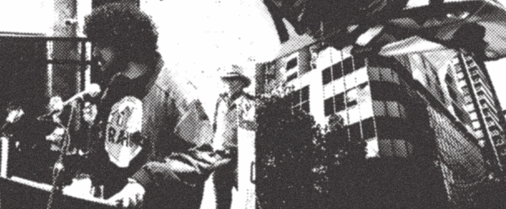 RAHU Secretary making a speech on the left, an apartment on the right.